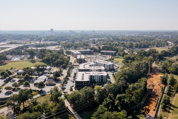 Aerial view of an apartment community surrounded by trees